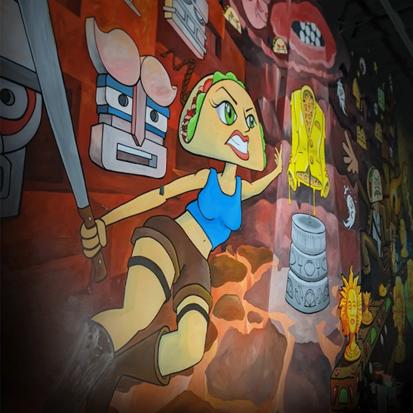 Hand-painted restaurant mural of a cartoon taco hero