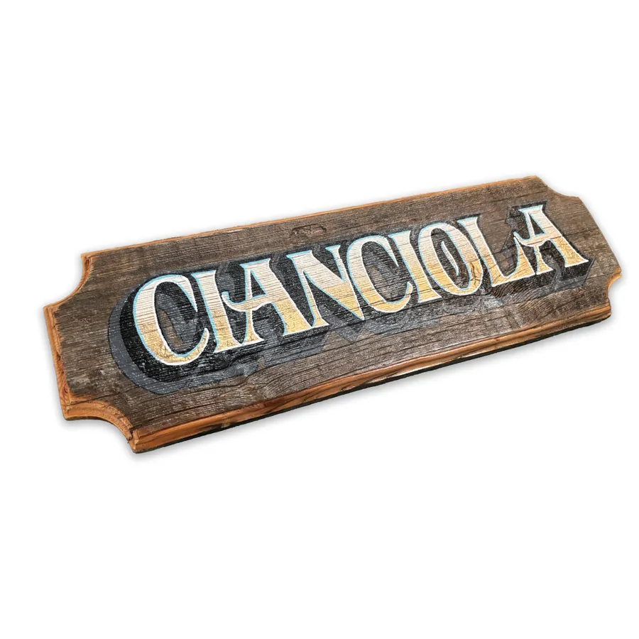 Hand-carved wooden family name sign with painted lettering